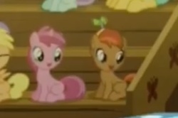 Size: 341x227 | Tagged: safe, screencap, button mash, mango dash, ruby pinch, earth pony, pony, g4, on your marks, colt, cropped, duo, duo focus, duo male and female, female, filly, foal, liquid button, male, ponies sitting next to each other