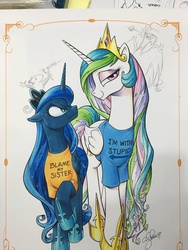 Size: 1536x2048 | Tagged: safe, artist:andypriceart, edit, idw, philomena, princess celestia, princess luna, tiberius, alicorn, opossum, phoenix, pony, g4, andy you magnificent bastard, angry, bedroom eyes, blame my sister, clothes, crown, duo, female, frown, glare, i'm with stupid, jewelry, looking at you, luna is not amused, magic shirt, mare, raised hoof, regalia, royal sisters, shirt, siblings, sisters, slingshot, smiling, smirk, text on clothing, text on shirt, trollestia, unamused