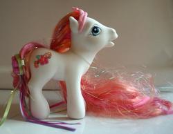 Size: 750x582 | Tagged: safe, photographer:lilcricketnoise, aloha pearl, earth pony, pony, g3, crown, female, hairclip, irl, jewelry, mare, photo, regalia, ribbon, solo, super long hair pony, tinsel in mane, toy