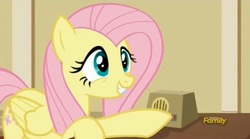 Size: 1674x934 | Tagged: safe, screencap, fluttershy, pegasus, pony, g4, viva las pegasus, cute, female, grin, intercom, mare, raised hoof, shyabetes, smiling