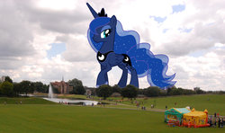 Size: 1024x606 | Tagged: safe, artist:theotterpony, princess luna, alicorn, human, pony, g4, bouncy castle, female, fountain, giant pony, irl, irl human, lidded eyes, macro, mare, mega luna, park, photo, ponies in real life, smiling