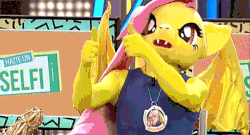 Size: 600x324 | Tagged: safe, fluttershy, bat pony, human, g4, animated, clothes, cosplay, costume, flutterbat, fursuit, gif, interview, irl, irl human, photo, race swap, spanish, thumbs up, tv show