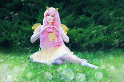 Size: 1280x853 | Tagged: safe, artist:tinemarieriis, fluttershy, human, g4, clothes, cosplay, costume, heart hands, irl, irl human, one eye closed, photo, sitting, smiling, solo, wink