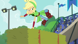 Size: 1280x720 | Tagged: safe, screencap, applejack, equestria girls, g4, my little pony equestria girls: friendship games, archery, audience, boots, canterlot high, clothes, female, freckles, hay bale, leaping, pants, solo