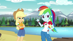 Size: 1280x720 | Tagged: safe, screencap, applejack, rainbow dash, equestria girls, g4, my little pony equestria girls: legend of everfree, clothes, cowboy hat, crossed arms, denim, female, freckles, hat, lake, lifejacket, mountain, mountain range, pants, pointing, scenery, shorts, smirk, stetson, tree