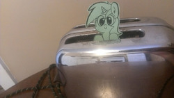 Size: 1280x722 | Tagged: safe, artist:davierocket, lyra heartstrings, pony, unicorn, g4, craft, irl, papercraft, photo, ponies in real life, smiling, solo, tiny ponies, toaster