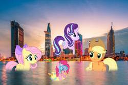 Size: 1800x1200 | Tagged: safe, applejack, fluttershy, pinkie pie, starlight glimmer, pony, g4, bitexco financial tower, flutterduck, giant pony, giant starlight glimmer, ho chi minh city, irl, macro, photo, ponies in real life, swimming, vietnam, water