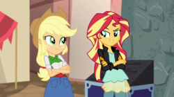 Size: 1280x718 | Tagged: safe, screencap, applejack, sunset shimmer, equestria girls, equestria girls specials, g4, my little pony equestria girls: movie magic, >:d, clothes, cowboy hat, crossed arms, denim skirt, evil grin, freckles, grin, hat, jacket, leather jacket, looking at each other, pants, skirt, smiling, smirk, stetson
