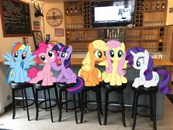 Size: 4032x3024 | Tagged: safe, applejack, fluttershy, pinkie pie, rainbow dash, rarity, twilight sparkle, alicorn, earth pony, pegasus, pony, unicorn, g4, bar, clock, espn, female, grin, head tilt, irl, lake house pub, mane six, mare, michigan, new buffalo, open mouth, photo, photoshop, ponies in real life, sitting, smiling, spread wings, stool, television, wings