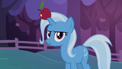 Size: 1920x1080 | Tagged: safe, screencap, trixie, pony, unicorn, g4, uncommon bond, apple, female, fence, food, horn, horn guard, horn impalement, mare, solo