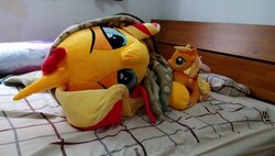 Size: 1200x683 | Tagged: safe, artist:nekokevin, applejack, fluttershy, sunset shimmer, earth pony, pegasus, pony, unicorn, g4, bed, bedroom eyes, bedsheets, female, irl, life size, looking at you, lying down, mare, on side, photo, pillow, plushie, size difference, smiling, upside down