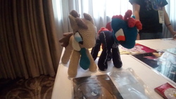 Size: 2560x1440 | Tagged: safe, artist:knittedstable, doctor whooves, time turner, oc, oc:nessie, g4, convention, duo, indoors, irl, knitted stable, photo, plushie, table