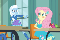 Size: 672x454 | Tagged: safe, screencap, fluttershy, trixie, bird, songbird, a little birdie told me, equestria girls, g4, my little pony equestria girls: better together, blushing, classroom, female, geode of fauna, looking at each other, magical geodes, pointing, school desk