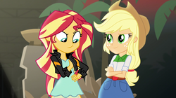 Size: 1912x1072 | Tagged: safe, screencap, applejack, sunset shimmer, equestria girls, equestria girls specials, g4, my little pony equestria girls: movie magic, duo, faic, looking at each other, out of context, plant, smiling, smug