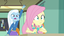 Size: 1920x1080 | Tagged: safe, screencap, fluttershy, trixie, a little birdie told me, equestria girls, g4, my little pony equestria girls: better together, female, geode of fauna, magical geodes, raised hand
