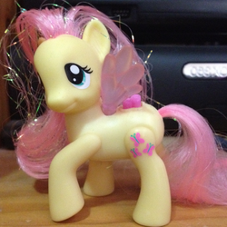 Size: 712x712 | Tagged: safe, edit, fluttershy, pony, g4, brushable, cropped, irl, merchandise, mirrored, photo, solo, toy