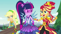 Size: 1280x720 | Tagged: safe, screencap, applejack, sci-twi, sunset shimmer, twilight sparkle, equestria girls, g4, my little pony equestria girls: legend of everfree, alternate hairstyle, clothes, crystal guardian, crystal wings, gloves, log, open mouth, pants, super strength