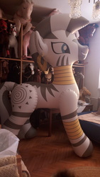 Size: 2592x4608 | Tagged: safe, artist:arniemkii, zecora, horse, pony, zebra, g4, bootleg, carpet, chandelier, earring, female, hongyi, indoors, inflatable, inflatable toy, inflatable zebra, irl, jewelry, leg rings, mare, neck rings, opaque inflatable, parquet, photo, piercing, shelf, standing