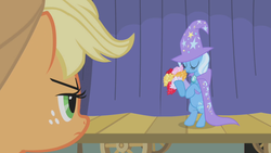 Size: 1280x720 | Tagged: safe, screencap, applejack, trixie, earth pony, pony, unicorn, boast busters, g4, applejack is not amused, bipedal, bouquet, cape, clothes, cute, diatrixes, eyes closed, female, flower, freckles, hat, mare, trixie's cape, trixie's hat, unamused