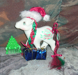 Size: 901x870 | Tagged: safe, artist:fizzy--love, merry treat, g1, bow, comb, hat, irl, photo, present, santa hat, solo, tail bow, toy