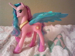 Size: 640x480 | Tagged: safe, artist:mylittleprimo, princess celestia, g4, bed, blue wings, colored wings, electronic toy, irl, photo, pinklestia, solo, toy, wings