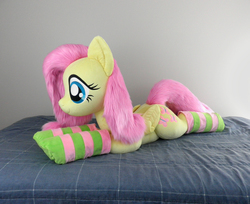 Size: 2453x2000 | Tagged: safe, artist:qtpony, fluttershy, pony, g4, adorable face, bed, bedroom, clothes, cute, fluffy, high res, irl, life size, lying down, photo, plushie, show accurate, shyabetes, socks, solo, striped socks