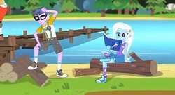 Size: 446x244 | Tagged: safe, screencap, micro chips, trixie, equestria girls, g4, my little pony equestria girls: legend of everfree, background human, camp everfree outfits, clothes, converse, glasses, logs, pier, reading, shoes, shorts, sitting, sneakers, socks