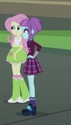 Size: 210x368 | Tagged: safe, screencap, fluttershy, sunny flare, equestria girls, g4, my little pony equestria girls: friendship games, boots, clothes, crystal prep academy uniform, female, hand on elbow, hand on hip, high heel boots, raised leg, school uniform, shoes, skirt, socks