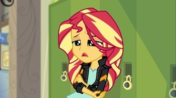 Size: 1100x618 | Tagged: safe, screencap, sunset shimmer, equestria girls, g4, my little pony equestria girls: friendship games, clothes, female, hand on arm, hand on elbow, jacket, leather jacket, lockers, solo