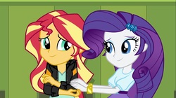 Size: 1100x618 | Tagged: safe, screencap, rarity, sunset shimmer, equestria girls, g4, my little pony equestria girls: friendship games, bracelet, clothes, comforting, duo, female, hairpin, hands on arms, jacket, jewelry, leather jacket, lockers, smiling