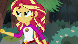 Size: 1280x720 | Tagged: safe, screencap, sunset shimmer, equestria girls, g4, my little pony equestria girls: legend of everfree, camp everfree outfits, clothes, female, fist, flower, scenery, shorts, solo, tree