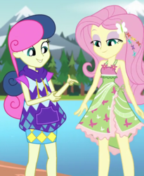 Size: 500x610 | Tagged: safe, screencap, bon bon, fluttershy, sweetie drops, equestria girls, g4, my little pony equestria girls: legend of everfree, armpits, bare shoulders, boho, camp fashion show outfit, clothes, cropped, dress, female, flower, lidded eyes, looking at self, looking good, mountain, river, sleeveless, tree