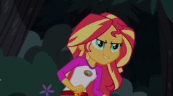 Size: 1100x618 | Tagged: safe, screencap, sunset shimmer, equestria girls, g4, my little pony equestria girls: legend of everfree, >:d, camp everfree outfits, clothes, evil smile, female, flower, grin, happy, shorts, smiling, smirk, solo