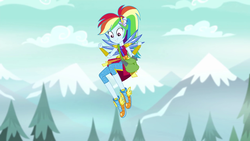 Size: 1280x720 | Tagged: safe, screencap, rainbow dash, equestria girls, g4, my little pony equestria girls: legend of everfree, clothes, crystal guardian, crystal wings, female, flying, legend you were meant to be, mountain, pants, ponied up, shoes, shoulder bag, sneakers, solo, super ponied up, tree, winged shoes, wings