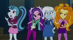 Size: 1280x714 | Tagged: safe, screencap, adagio dazzle, aria blaze, sonata dusk, trixie, equestria girls, g4, my little pony equestria girls: rainbow rocks, bracelet, clothes, evil grin, fall formal outfits, fingerless gloves, gem, gloves, grin, hand on hip, hand on shoulder, jewelry, necktie, pendant, siren gem, smiling, spikes, the dazzlings