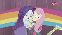 Size: 1136x638 | Tagged: safe, screencap, fluttershy, rarity, equestria girls, equestria girls specials, g4, my little pony equestria girls: dance magic, ballet slippers, canterlot high, clothes, duo, eyes closed, female, one eye open, open mouth, rainbow, skirt, teletoon