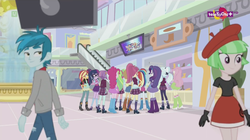 Size: 1136x638 | Tagged: safe, screencap, applejack, drama letter, fluttershy, lemon zest, pinkie pie, rainbow dash, rarity, sci-twi, sour sweet, sugarcoat, sunny flare, sunset shimmer, thunderbass, twilight sparkle, watermelody, equestria girls, equestria girls specials, g4, my little pony equestria girls: dance magic, background human, barrette, boots, bowtie, bracelet, canterlot mall, clothes, compression shorts, cowboy boots, cowboy hat, crossed arms, crystal prep academy uniform, denim skirt, glasses, gloves, hat, headphones, high heel boots, high heels, humane five, humane seven, humane six, jacket, jewelry, leather jacket, leggings, mall, mary janes, pigtails, pleated skirt, ponytail, rear view, ripped pants, school uniform, shoes, skirt, socks, stetson, teletoon, television, twintails
