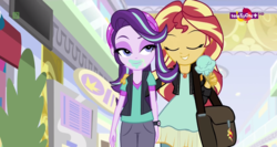 Size: 1364x724 | Tagged: safe, screencap, starlight glimmer, sunset shimmer, equestria girls, equestria girls specials, g4, mirror magic, bag, beanie, clothes, eating, face, food, geode of empathy, hat, hug, ice cream, ice cream cone, lidded eyes, magical geodes, messy eating, teletoon, thick, wat, wide hips