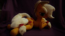 Size: 912x514 | Tagged: safe, artist:legadema, applejack, earth pony, pony, g4, irl, photo, plushie, prone, solo