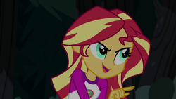 Size: 1280x720 | Tagged: safe, screencap, sunset shimmer, equestria girls, g4, my little pony equestria girls: legend of everfree, camp everfree outfits, clothes, female, night, open mouth, pointing, smiling, smirk, solo, talking