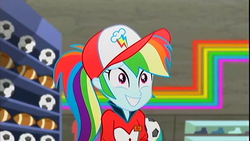 Size: 1400x789 | Tagged: safe, screencap, rainbow dash, epic fails (equestria girls), eqg summertime shorts, equestria girls, g4, alternate hairstyle, american football, baseball cap, cap, clothes, cute, cutie mark, cutie mark on clothes, dashabetes, female, football, grin, hat, name tag, neon, nervous, nervous smile, ponytail, shelf, shirt, shoes, smiling, solo, sports