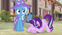 Size: 1280x720 | Tagged: safe, screencap, log jam, starlight glimmer, trixie, pony, unicorn, g4, to where and back again, cape, clothes, eyes closed, face down ass up, hat, our town, raised eyebrow, sitting, trixie's cape, trixie's hat, wavy mouth