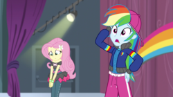 Size: 1280x718 | Tagged: safe, screencap, fluttershy, rainbow dash, equestria girls, equestria girls specials, g4, my little pony equestria girls: dance magic, arm behind head, backwards ballcap, baseball cap, cap, clothes, confused, female, hat, head scratch, hip hop, open mouth, outfit, pants, rapper dash, stage, street ballet tutu, tutu