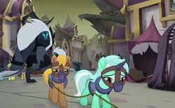 Size: 845x521 | Tagged: safe, screencap, lyra heartstrings, pony, g4, my little pony: the movie, background pony, bound together, canterlot, collar, cropped, harness, horn, horn cap, magic suppression, muzzle, ruins, sad, slavery, storm guard, tack