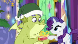 Size: 1280x720 | Tagged: safe, screencap, rarity, sludge (g4), dragon, pony, unicorn, father knows beast, g4, christmas, duo, female, hat, holiday, male, mare, present, santa hat