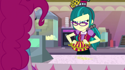 Size: 1920x1080 | Tagged: safe, screencap, juniper montage, pinkie pie, equestria girls, equestria girls specials, g4, mirror magic, apron, bauble, bracelet, cash register, cinema, clothes, female, food, frown, glasses, hair tie, hat, jewelry, pigtails, poofy shoulders, popcorn, scowl, shirt, skirt, soda machine, standing, twintails, uniform, vest
