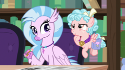 Size: 1280x720 | Tagged: safe, screencap, cozy glow, silverstream, classical hippogriff, hippogriff, pegasus, pony, g4, school raze, book, bookshelf, cozy glow is not amused, duo, female, filly, flying, foal, jewelry, necklace, pencil, saddle bag