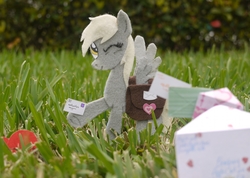 Size: 1500x1066 | Tagged: safe, artist:foxxy-arts, derpy hooves, pegasus, pony, g4, craft, derpy day, derpy day 2012, felt, grass, holding, irl, letter, mailmare, one eye closed, photo, ponies in real life, saddle bag, solo, spread wings, traditional art, wings, wink