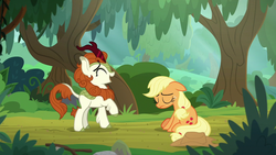 Size: 1280x720 | Tagged: safe, screencap, applejack, autumn blaze, earth pony, kirin, pony, g4, sounds of silence, duo, eyes closed, female, floppy ears, forest, laughing, mare, raised hoof, sitting