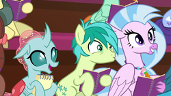 Size: 1280x720 | Tagged: safe, screencap, gallus, huckleberry, november rain, ocellus, peppermint goldylinks, sandbar, silverstream, yona, changedling, changeling, earth pony, hippogriff, pony, g4, the end in friend, cute, cutie mark, diaocelles, diastreamies, female, friendship student, male, notebook, offscreen character, pencil, sandabetes, teenager, wings